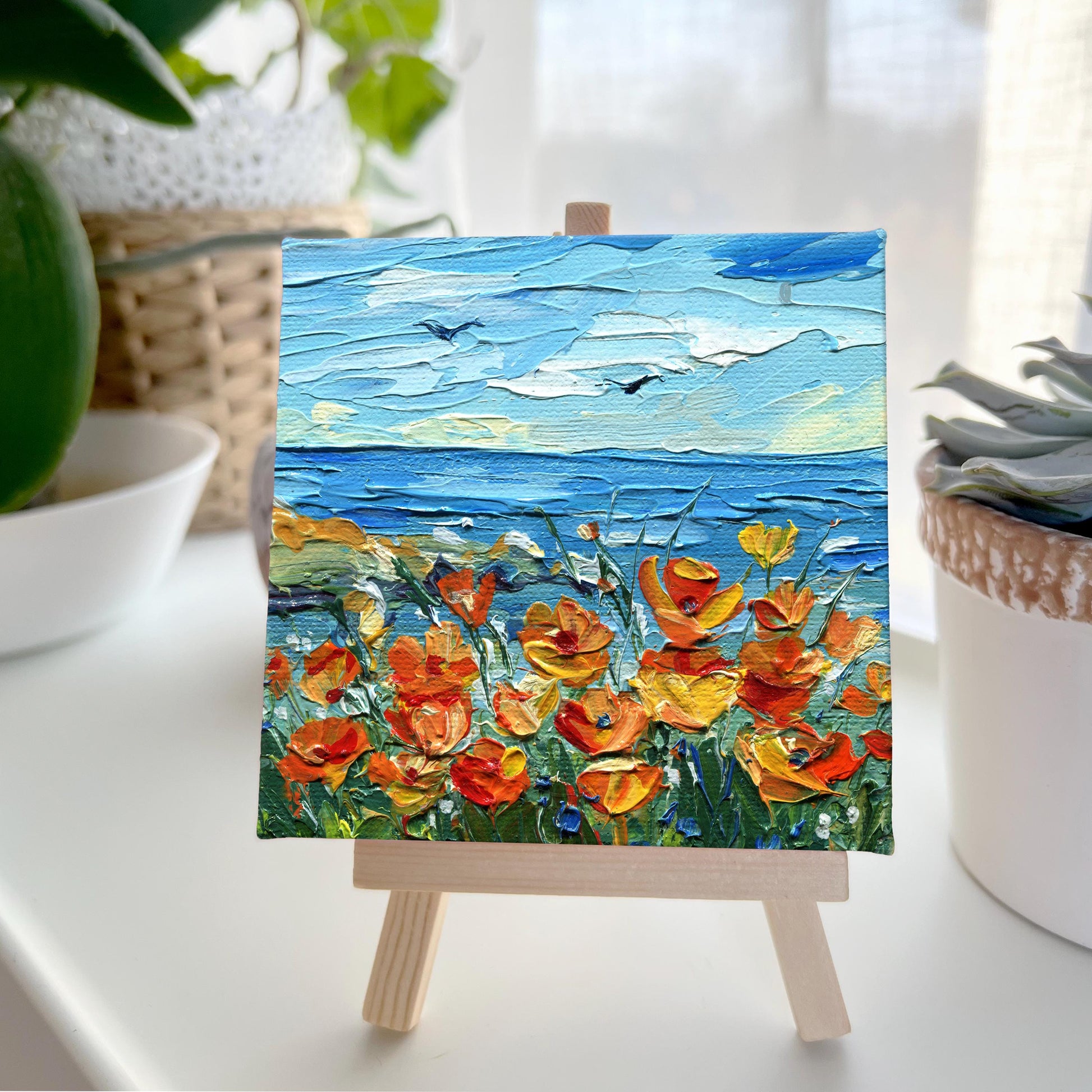 Angular perspective of California poppy textured canvas by Hanna Art emphasizing the sculptural paint layers and spirited knife strokes that animate the littoral flower scene with museum-quality craftsmanship