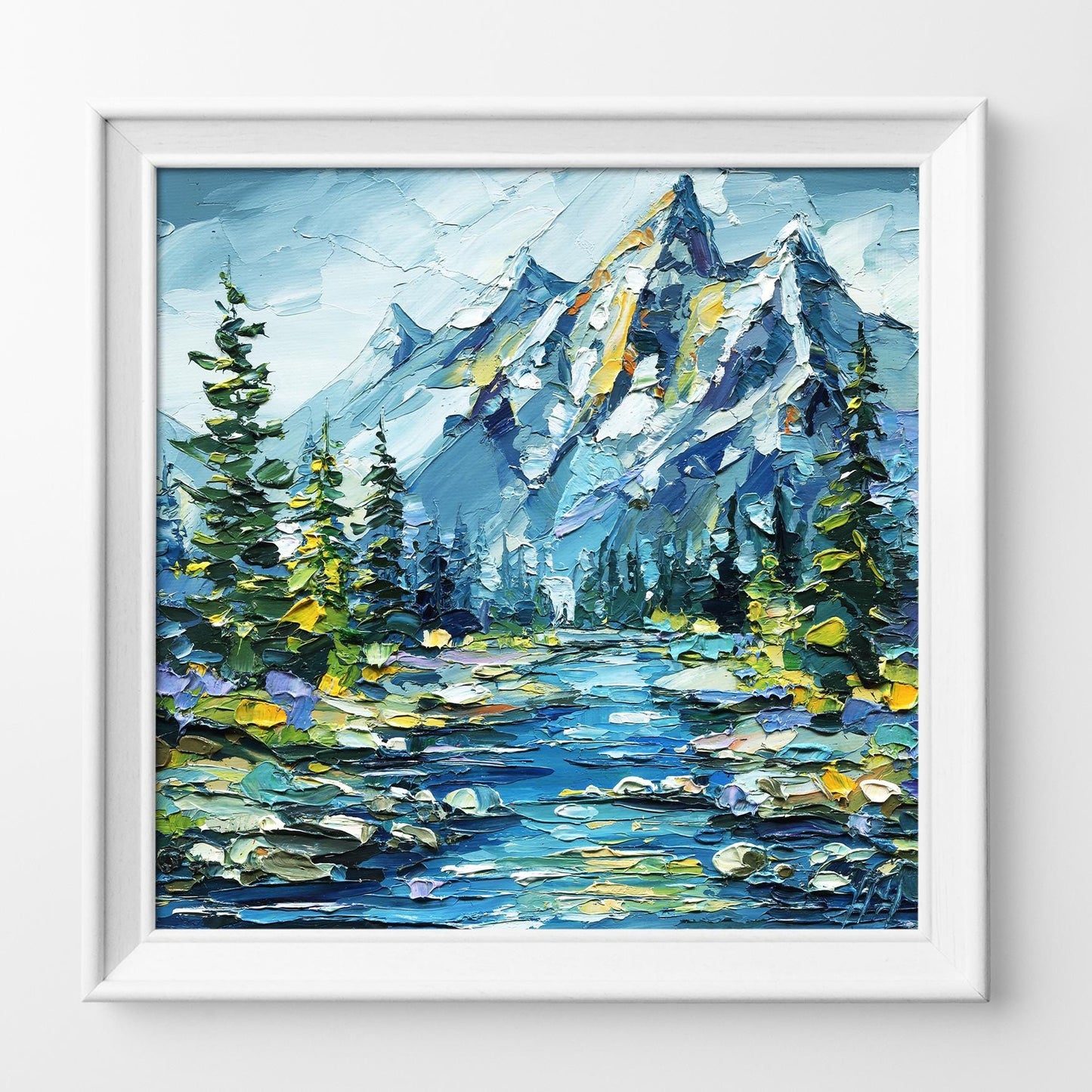 Framed painting of a mountain landscape with trees and water.