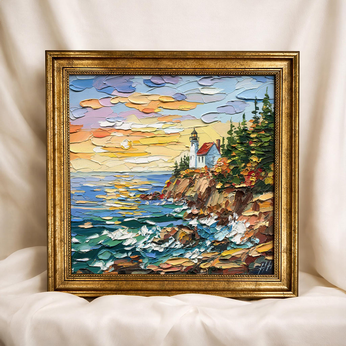 Overhead view of Acadia Lighthouse surrounded by oil paints, palette knives, and an artist’s palette